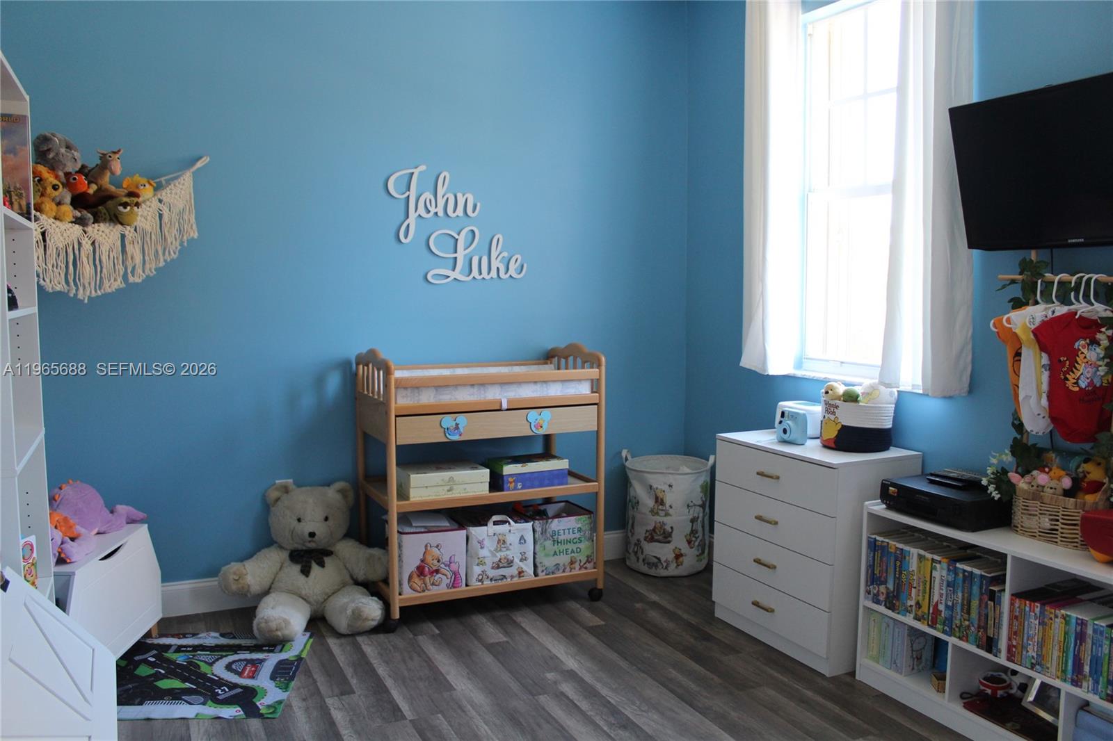 20135 Southwest 129th Avenue Miami, FL 33177 - Photo 22 of 54 a bedroom with baby toys and dresser