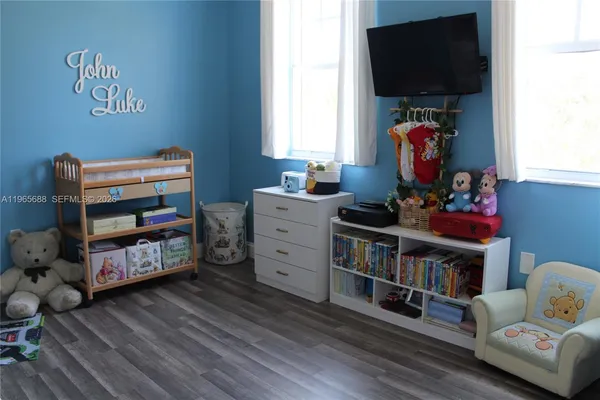 a living room with furniture and a book shelf