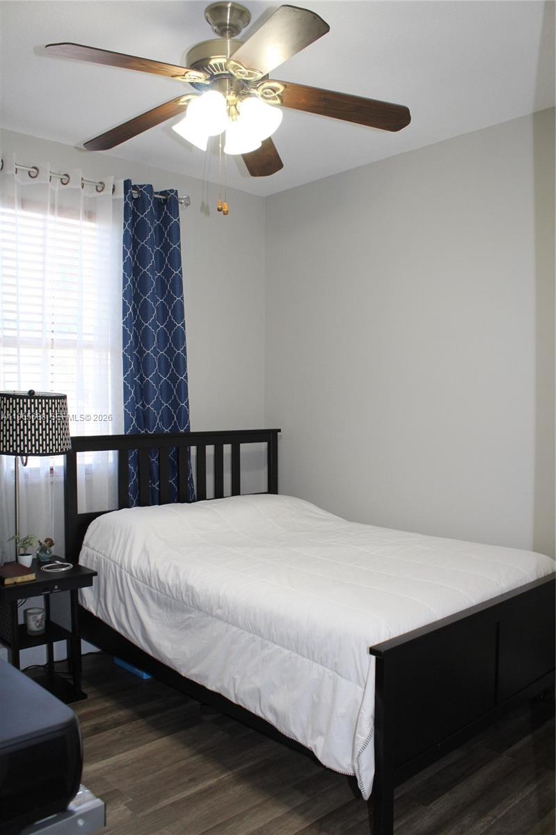20135 Southwest 129th Avenue Miami, FL 33177 - Photo 30 of 54 a bedroom with a bed and a chandelier