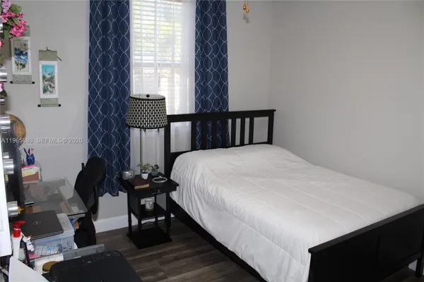 a bedroom with bed and a window