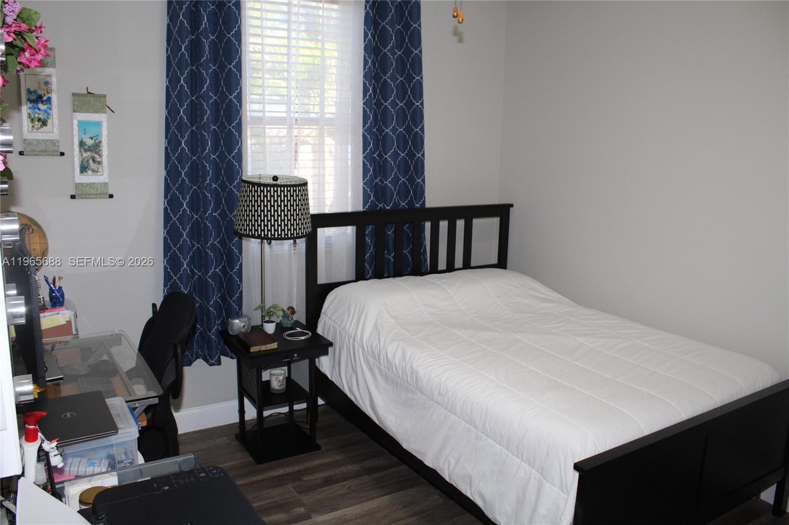 20135 Southwest 129th Avenue Miami, FL 33177 - Photo 31 of 54 a bed sitting in a bedroom next to a window