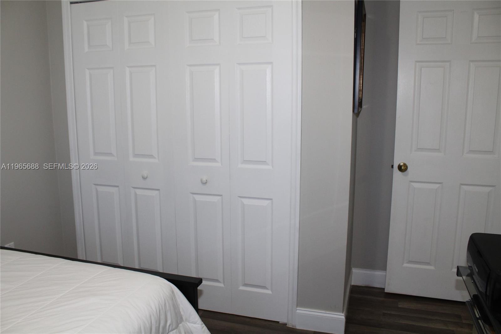 20135 Southwest 129th Avenue Miami, FL 33177 - Photo 33 of 54 a bedroom with a bed and wooden floor