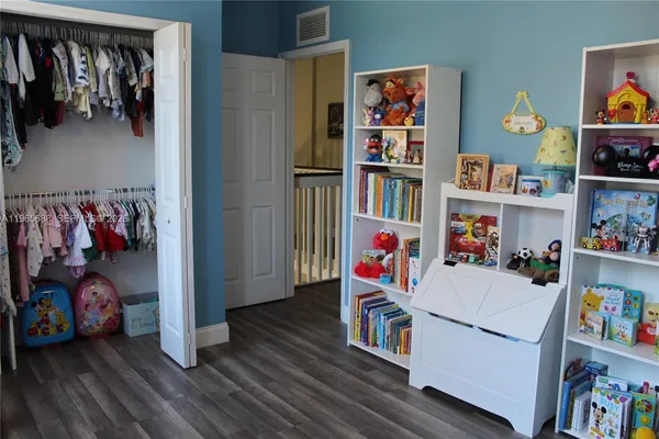 a kitchen with stainless steel appliances a stove cabinets and a wooden floor