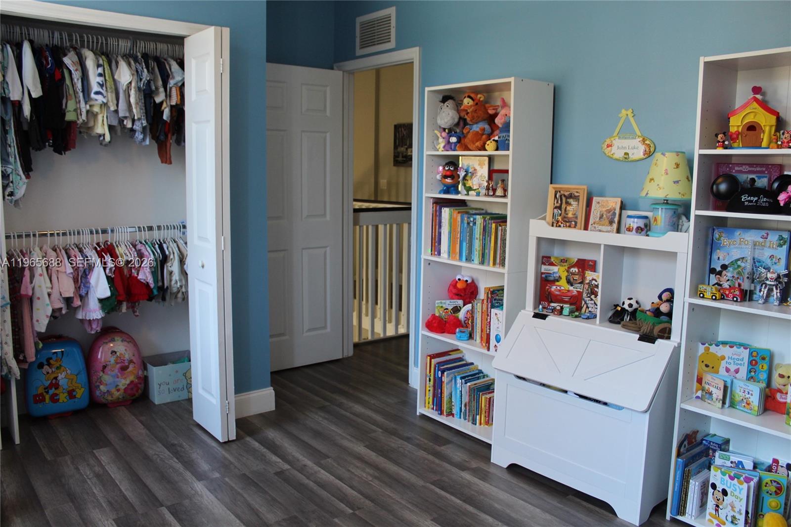 20135 Southwest 129th Avenue Miami, FL 33177 - Photo 36 of 54 a bedroom with furniture and a book shelf