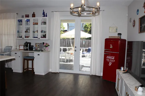 a kitchen with stainless steel appliances a refrigerator a sink a stove and white cabinets