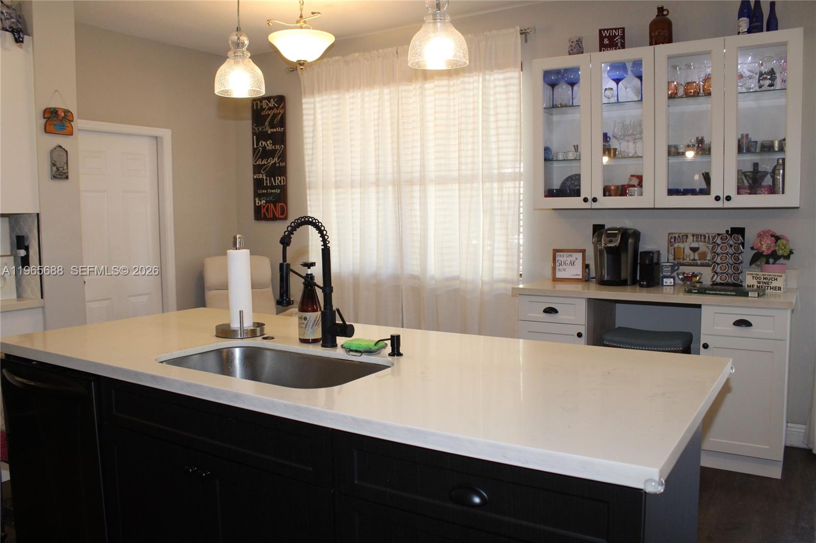 20135 Southwest 129th Avenue Miami, FL 33177 - Photo 38 of 54 a kitchen with a sink a stove and cabinets
