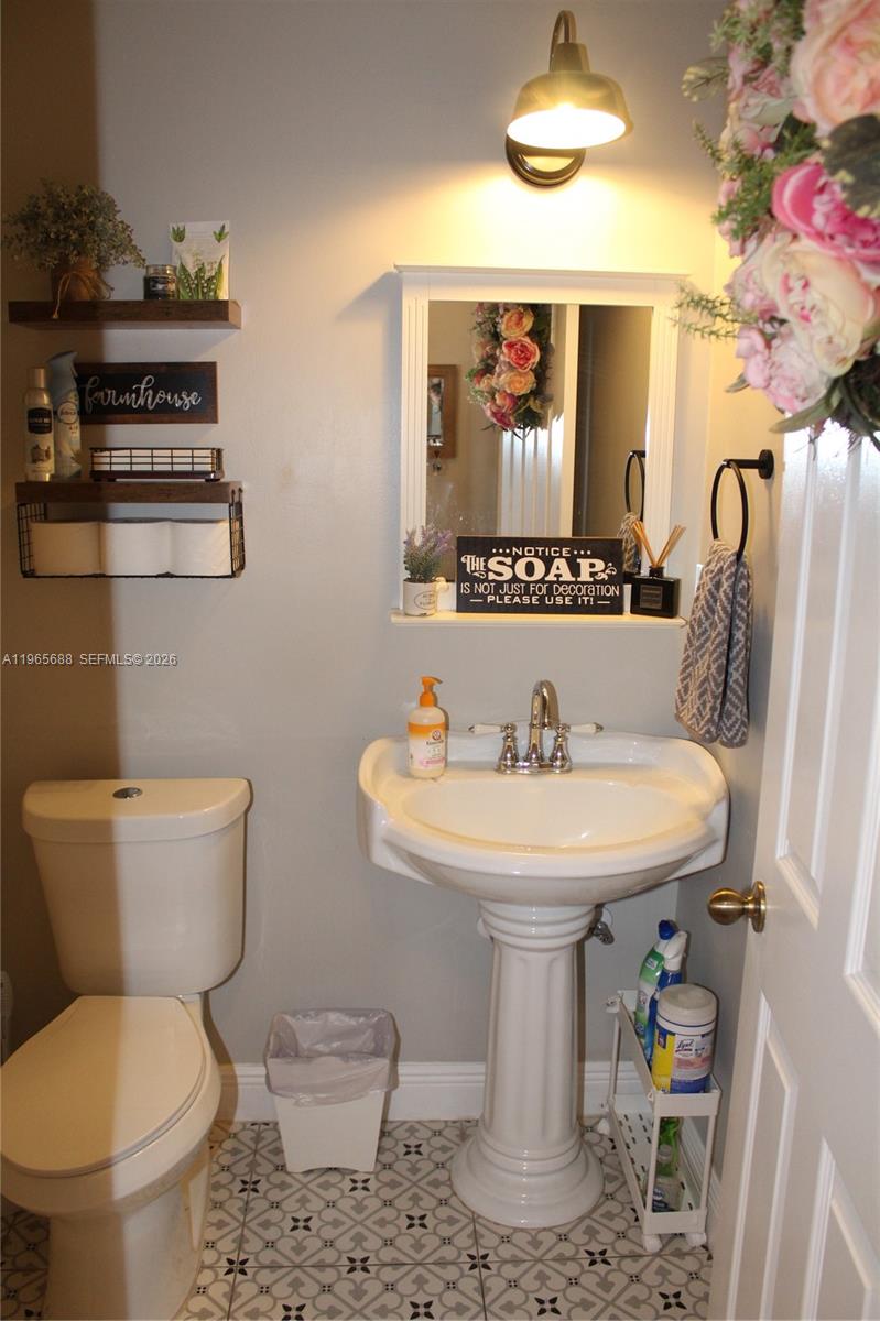 20135 Southwest 129th Avenue Miami, FL 33177 - Photo 4 of 54 a bathroom with a sink toilet and mirror