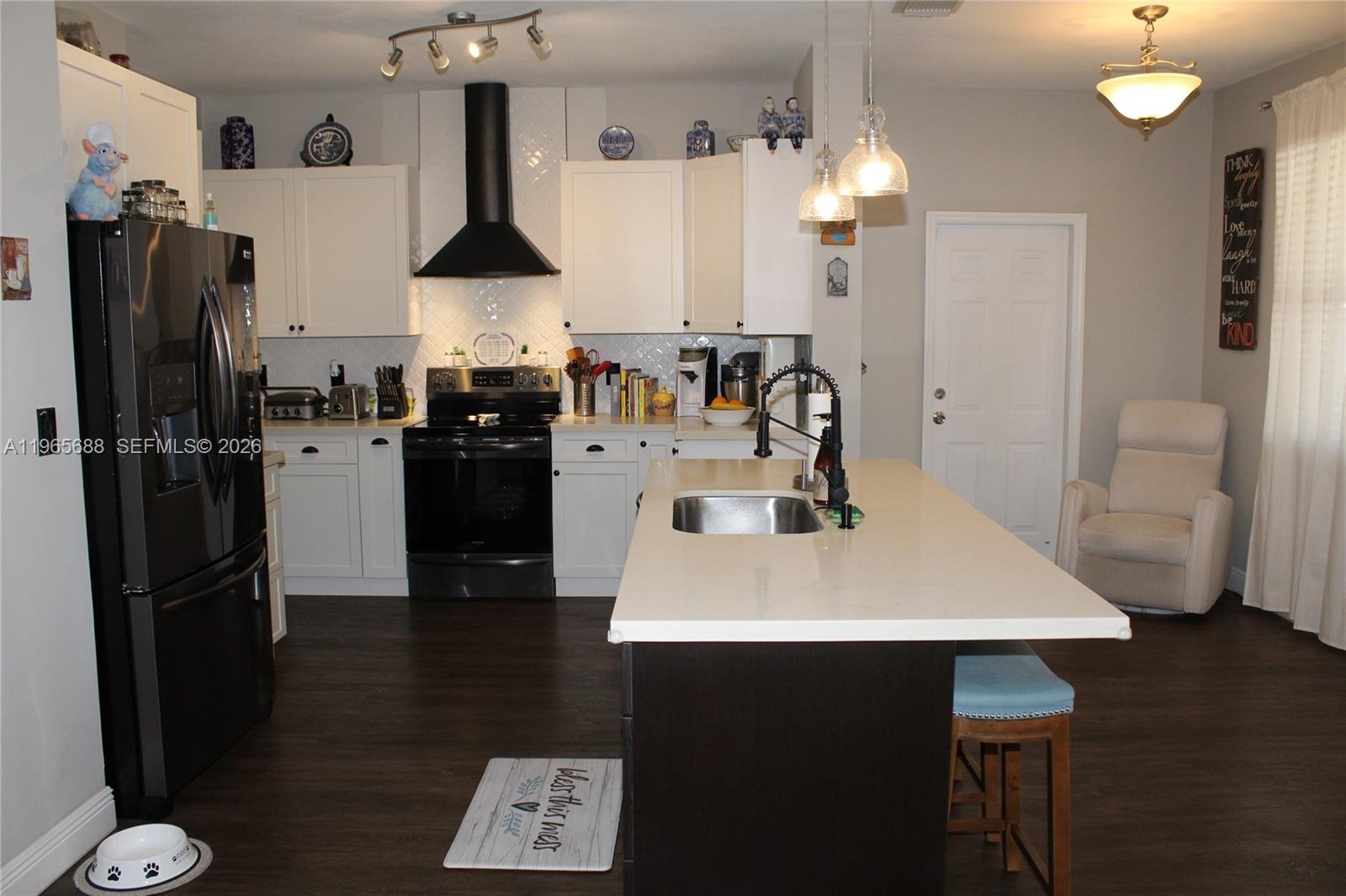 20135 Southwest 129th Avenue Miami, FL 33177 - Photo 44 of 54 a kitchen with stainless steel appliances a refrigerator and a stove