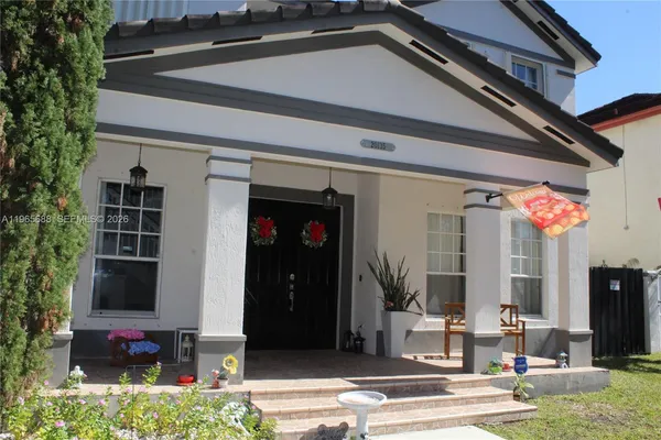 a view of a white house with large windows
