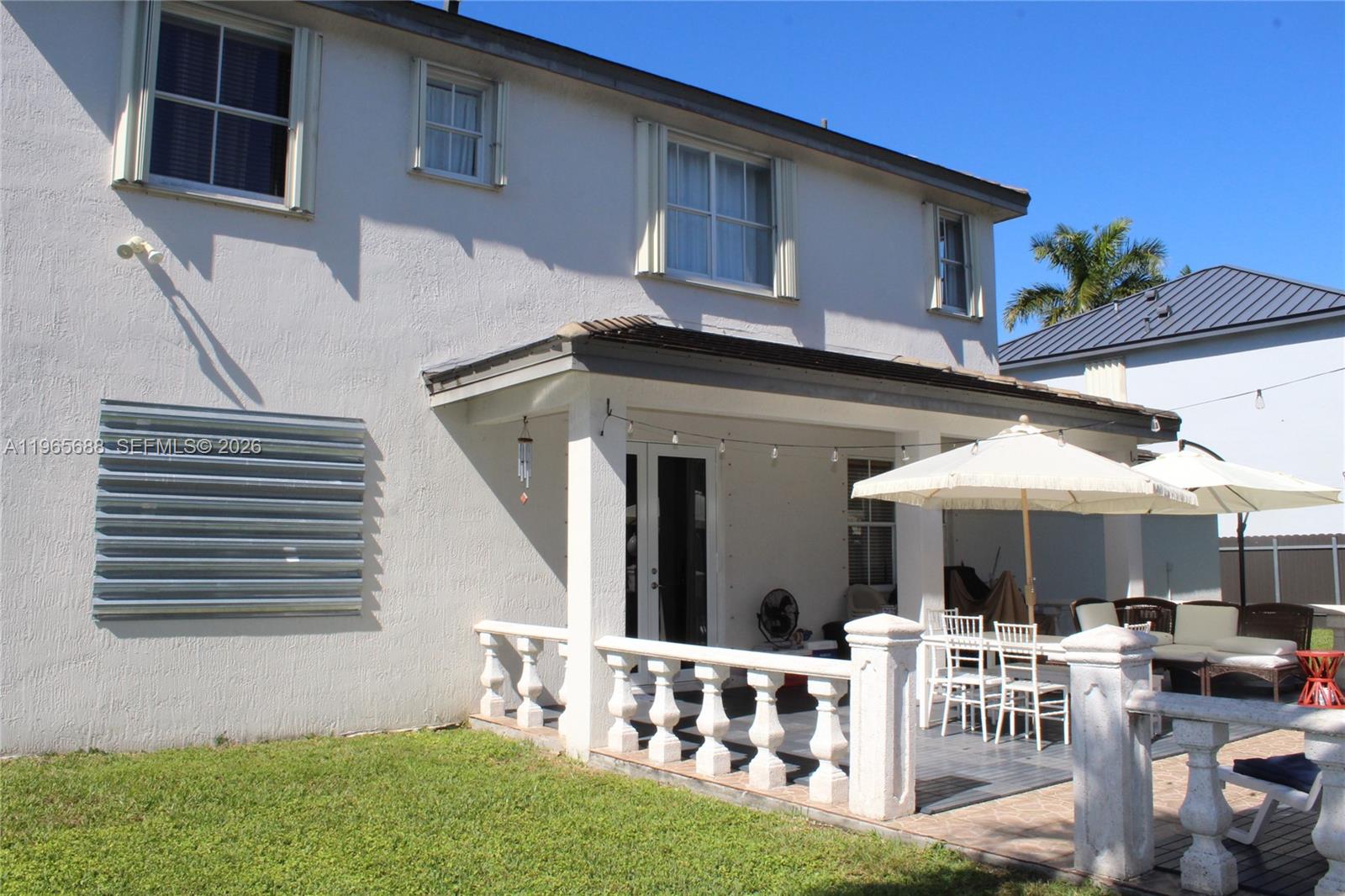 20135 Southwest 129th Avenue Miami, FL 33177 - Photo 49 of 54 a front view of house with yard outdoor seating and barbeque oven