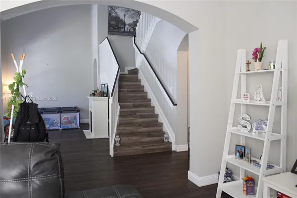 a view of entryway and workspace with wooden floor