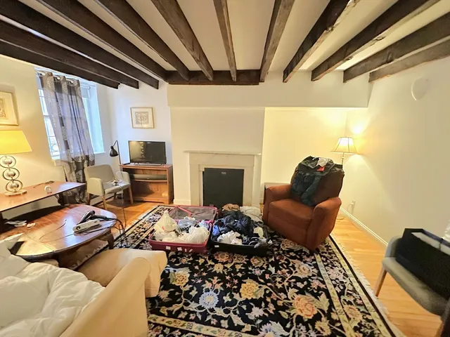 a bedroom with furniture and a fireplace