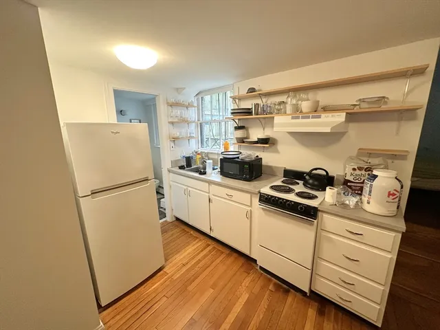 a white refrigerator freezer sitting inside of a kitchen