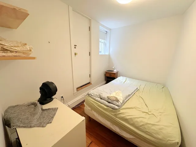 a bedroom with a bed and cabinets