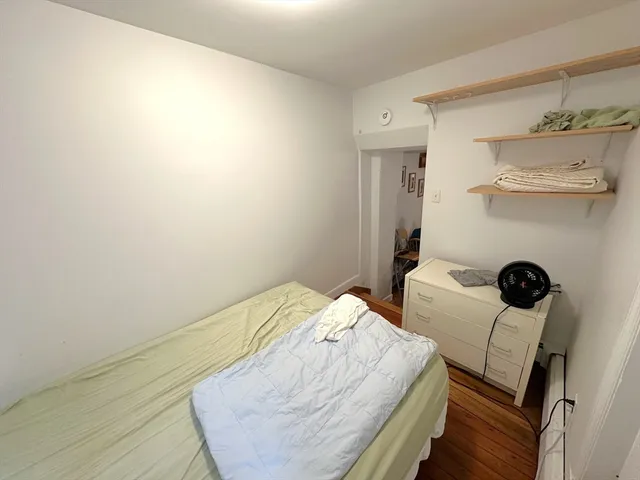 a bedroom with a bed and a table in it