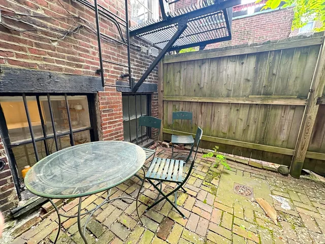 a view of a chairs and table in the patio