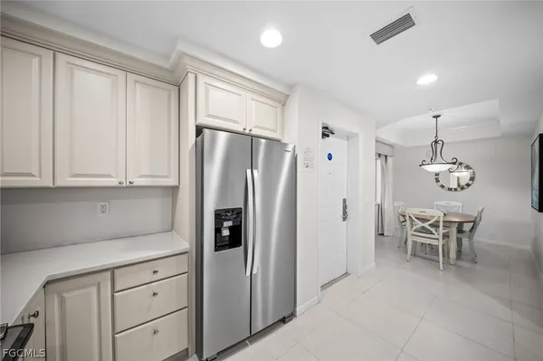 a kitchen with stainless steel appliances a refrigerator sink and cabinets