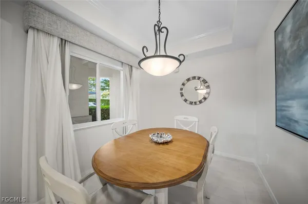 a view of dining room and chandelier fan