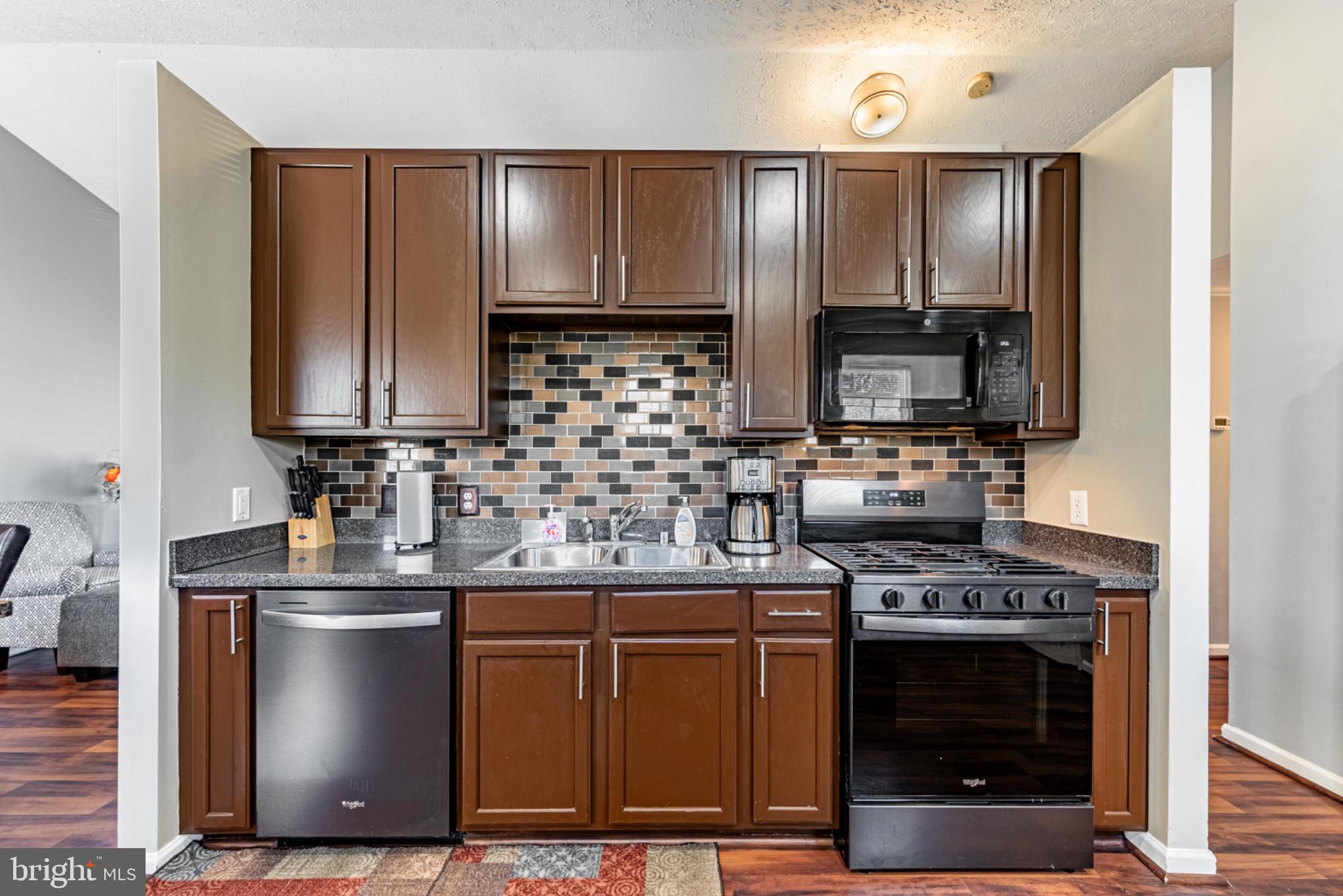 60 6 Point Court Baltimore, MD 21244 - Photo 11 of 28 a kitchen with stainless steel appliances granite countertop a stove a sink and a microwave
