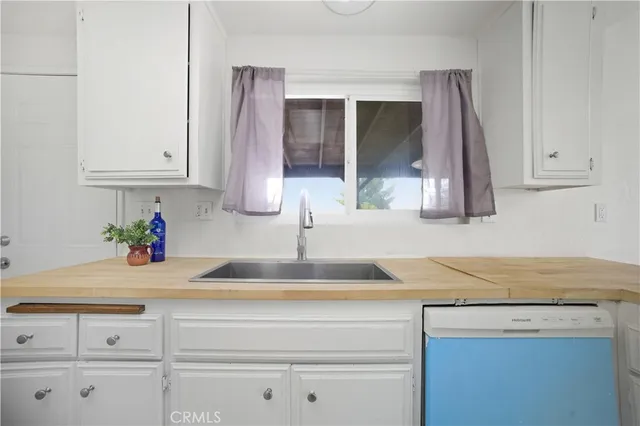 a kitchen with granite countertop a sink and cabinets