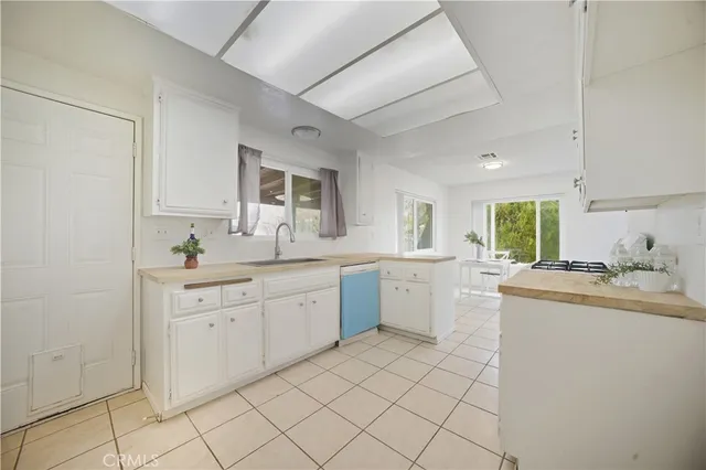 a kitchen with a sink cabinets and window