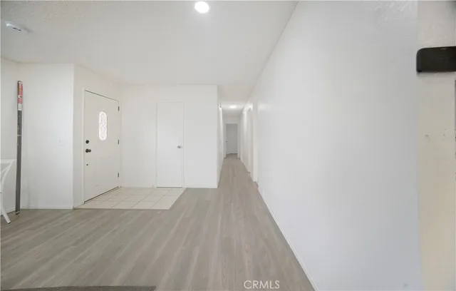 a view of a hallway with wooden floor