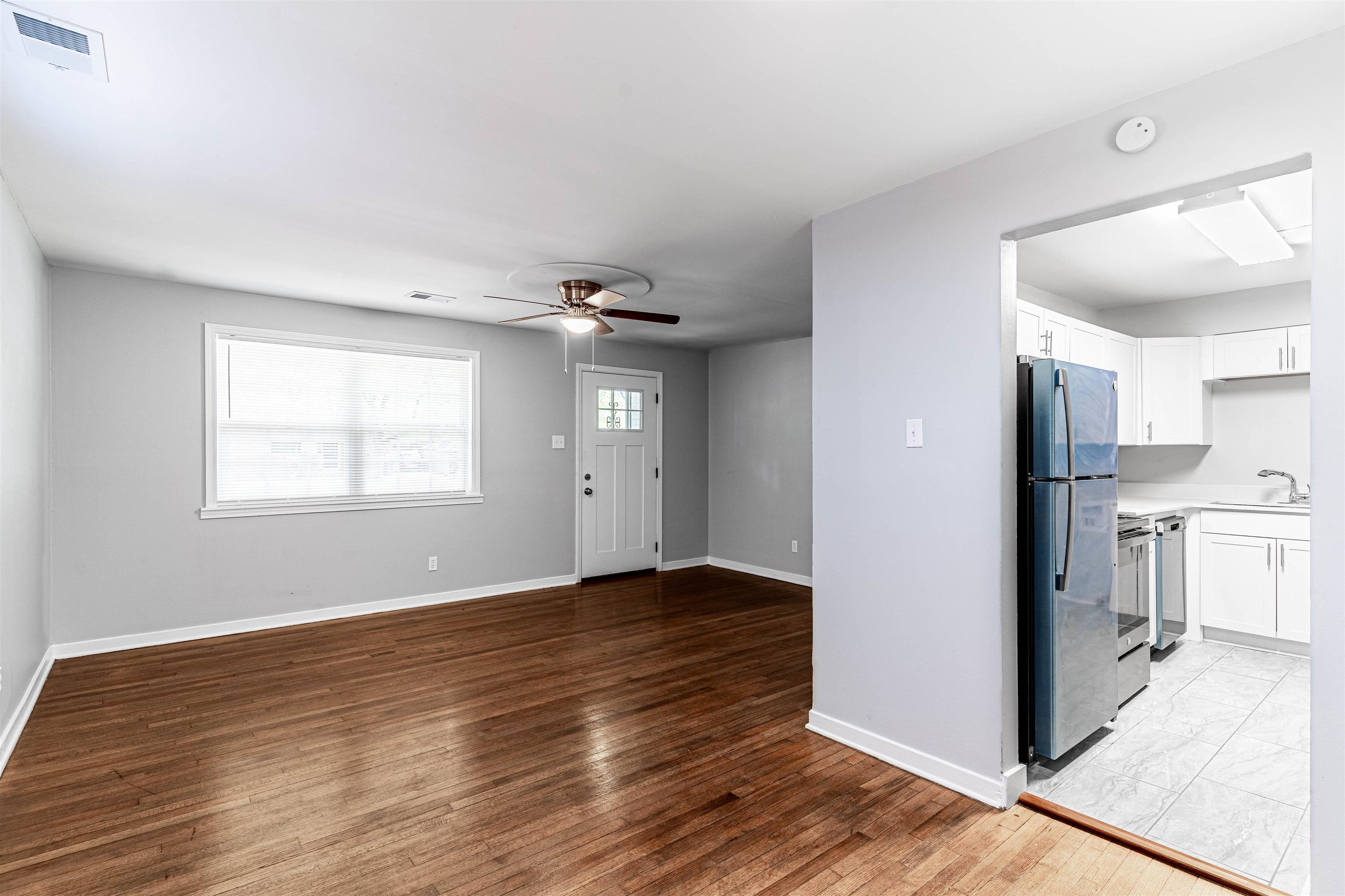 1141 South White Station Road Memphis, TN 38117 - Photo 4 of 9 a view of empty room with wooden floor and fan