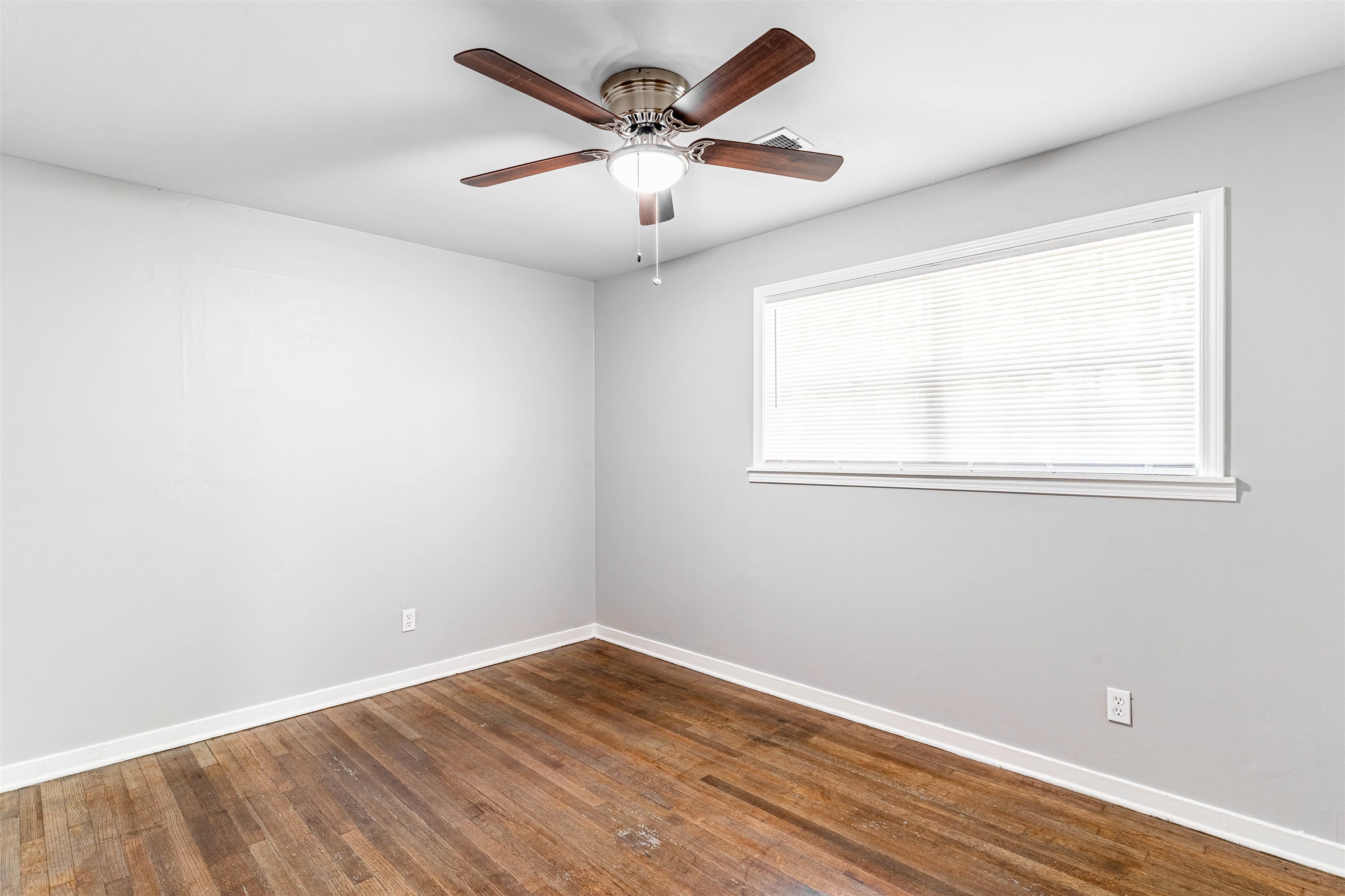 1141 South White Station Road Memphis, TN 38117 - Photo 8 of 9 an empty room with wooden floor and windows