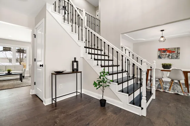 a view of entryway with wooden floor and stairs