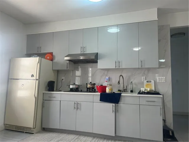 a kitchen with cabinets and white appliances