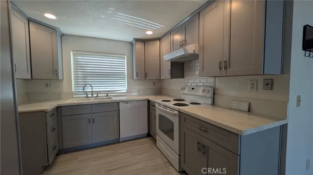 a kitchen with a sink stove and cabinets