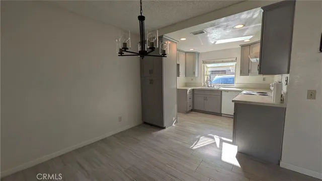 a room with wooden floor and white walls