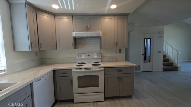 a kitchen with a stove top oven and cabinets