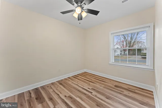 a view of room with window and ceiling fan