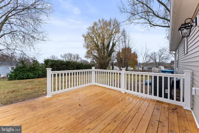 a balcony with wooden floor and trees