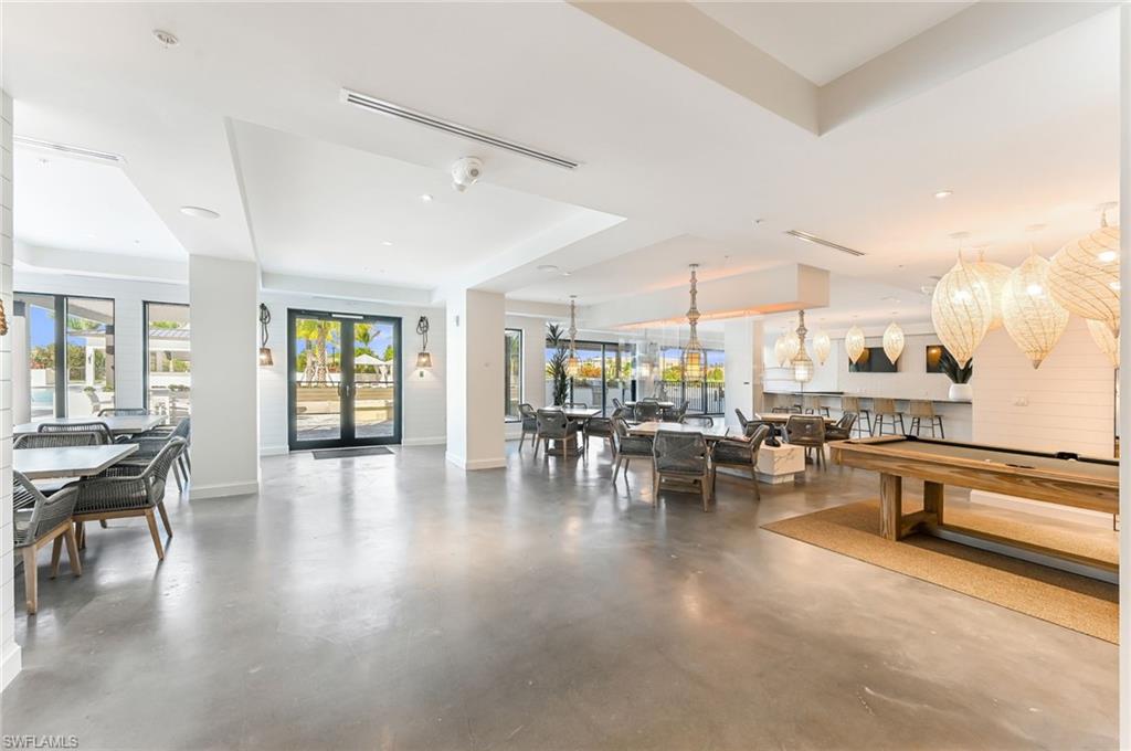 1111 Central, Unit 417A Naples, FL 34104 - Photo 21 of 25 a view of dining room with furniture and wooden floor