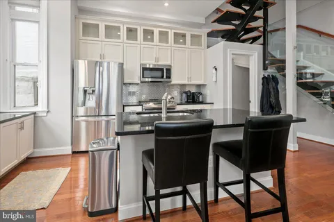 a kitchen with stainless steel appliances granite countertop a stove and a refrigerator