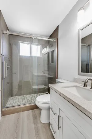 a bathroom with a sink toilet and shower