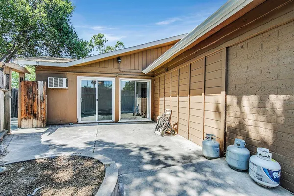 a view of a backyard with table and chairs and potted plants