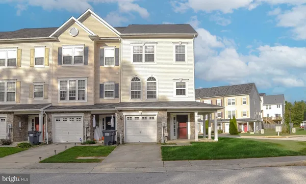 a front view of a building with a yard