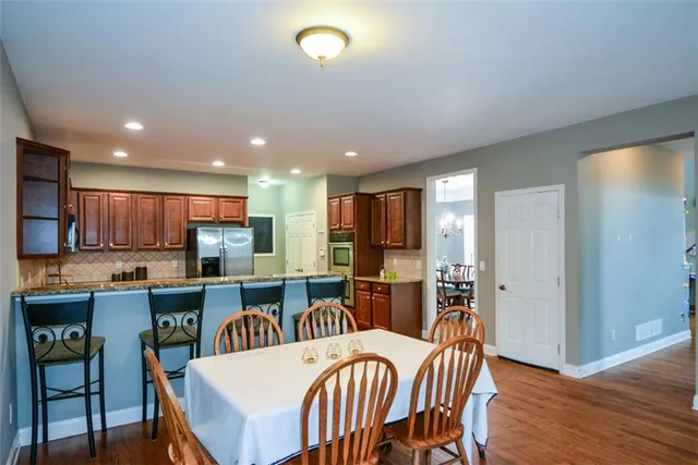 a front view of a house with a yard table and chairs