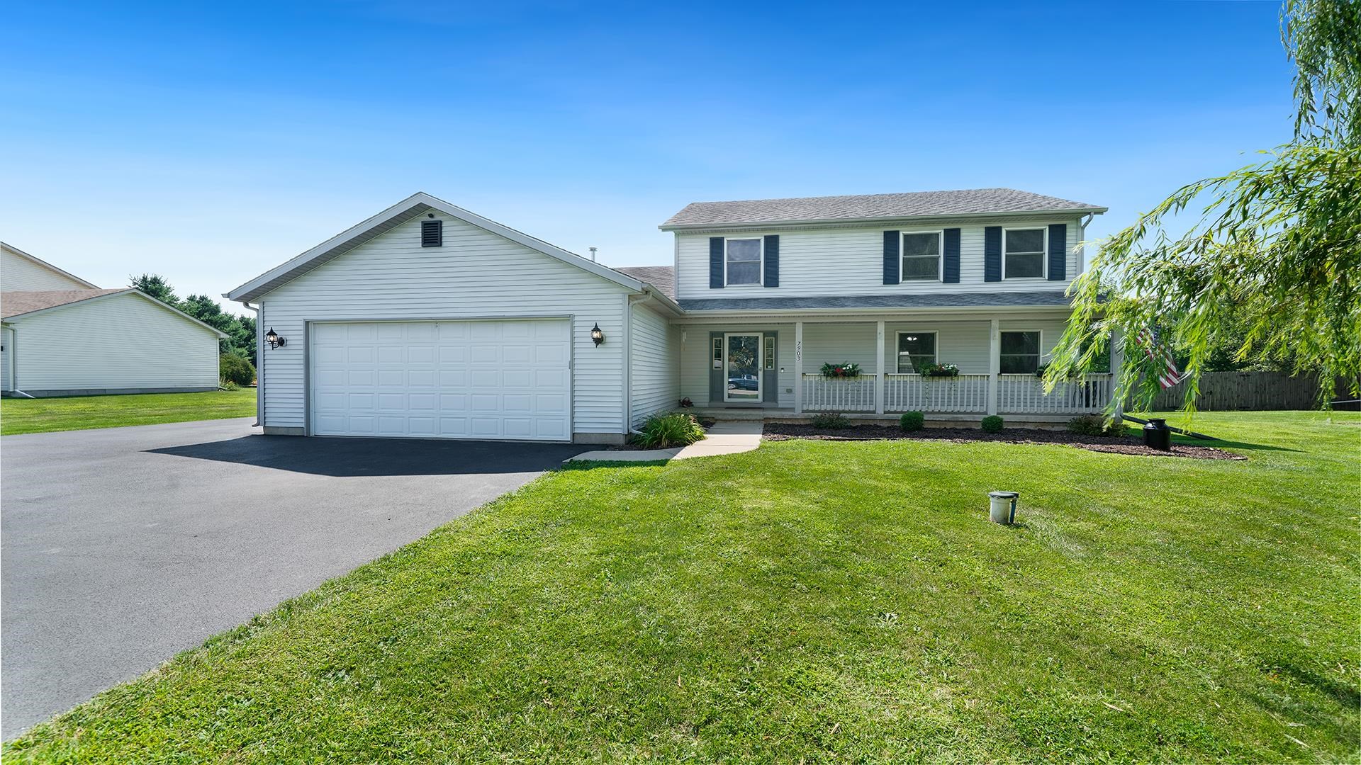 7903 Graf Road Harvard, IL 60033 - Photo 1 of 52 a front view of a house with a yard and trees