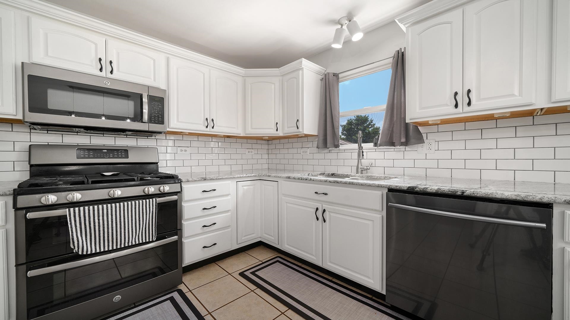 7903 Graf Road Harvard, IL 60033 - Photo 15 of 52 a kitchen with stainless steel appliances granite countertop a sink stove microwave and cabinets