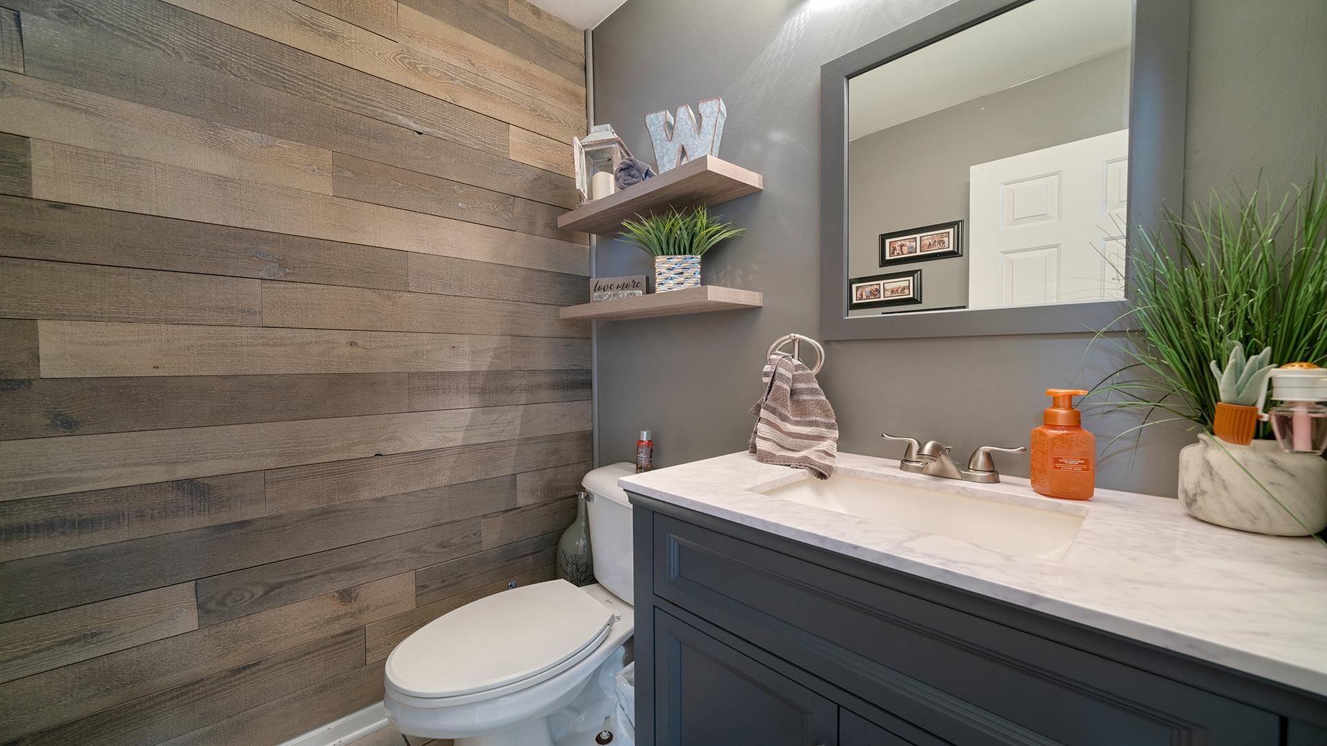 7903 Graf Road Harvard, IL 60033 - Photo 18 of 52 a bathroom with a sink a toilet and mirror