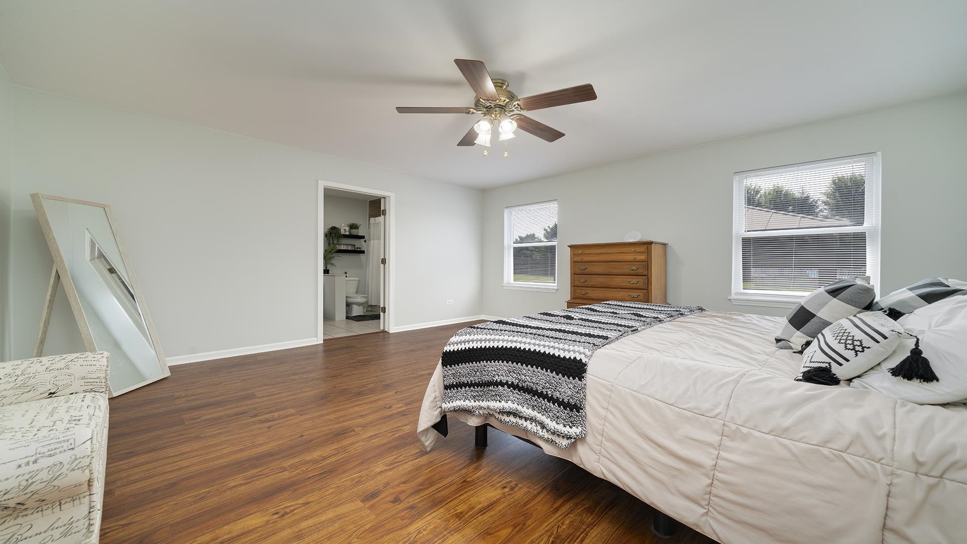 7903 Graf Road Harvard, IL 60033 - Photo 19 of 52 a bedroom with a bed and a chandelier