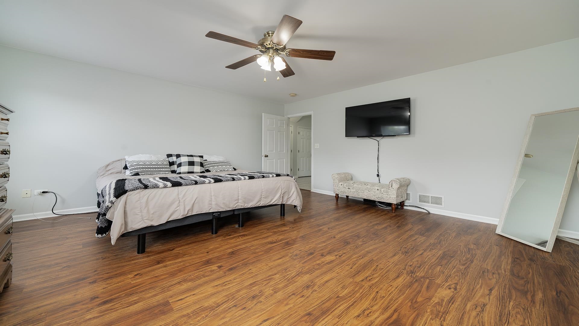 7903 Graf Road Harvard, IL 60033 - Photo 20 of 52 a bedroom with a bed a flat screen tv and a couch