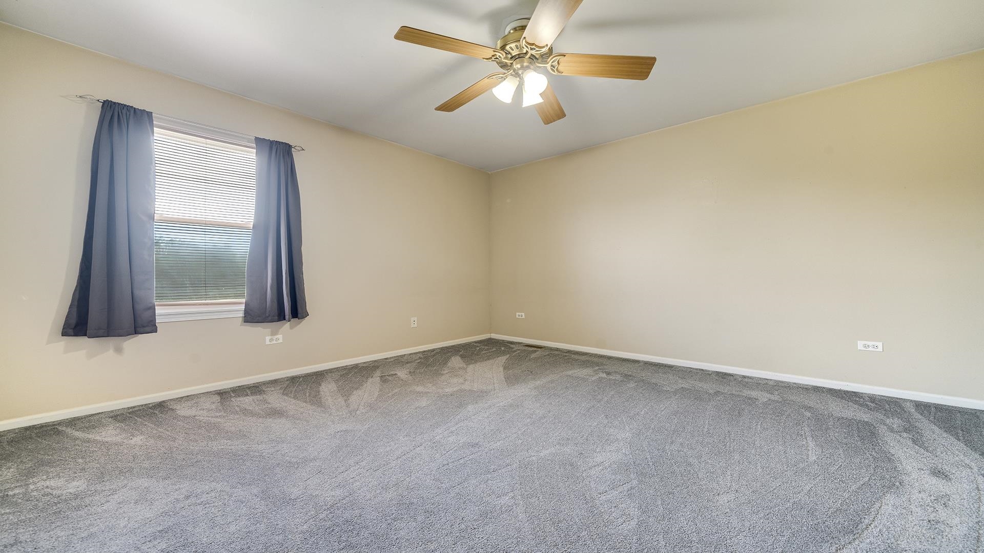 7903 Graf Road Harvard, IL 60033 - Photo 30 of 52 an empty room with windows and fan