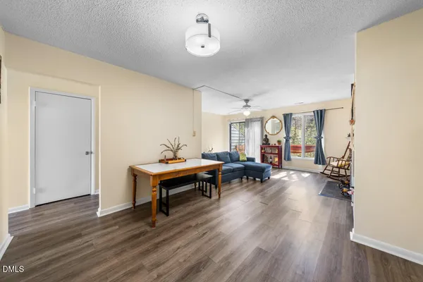 a view of a livingroom with furniture and hardwood floor