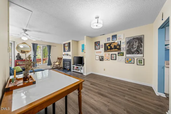a view of a livingroom with furniture hardwood floor and workspace