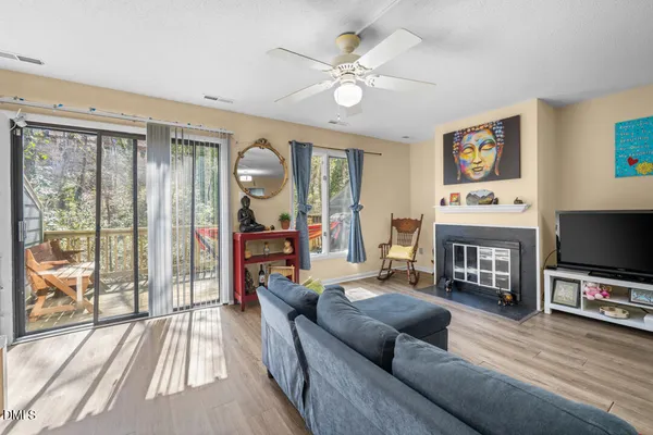 a living room with furniture and a flat screen tv with wooden floor